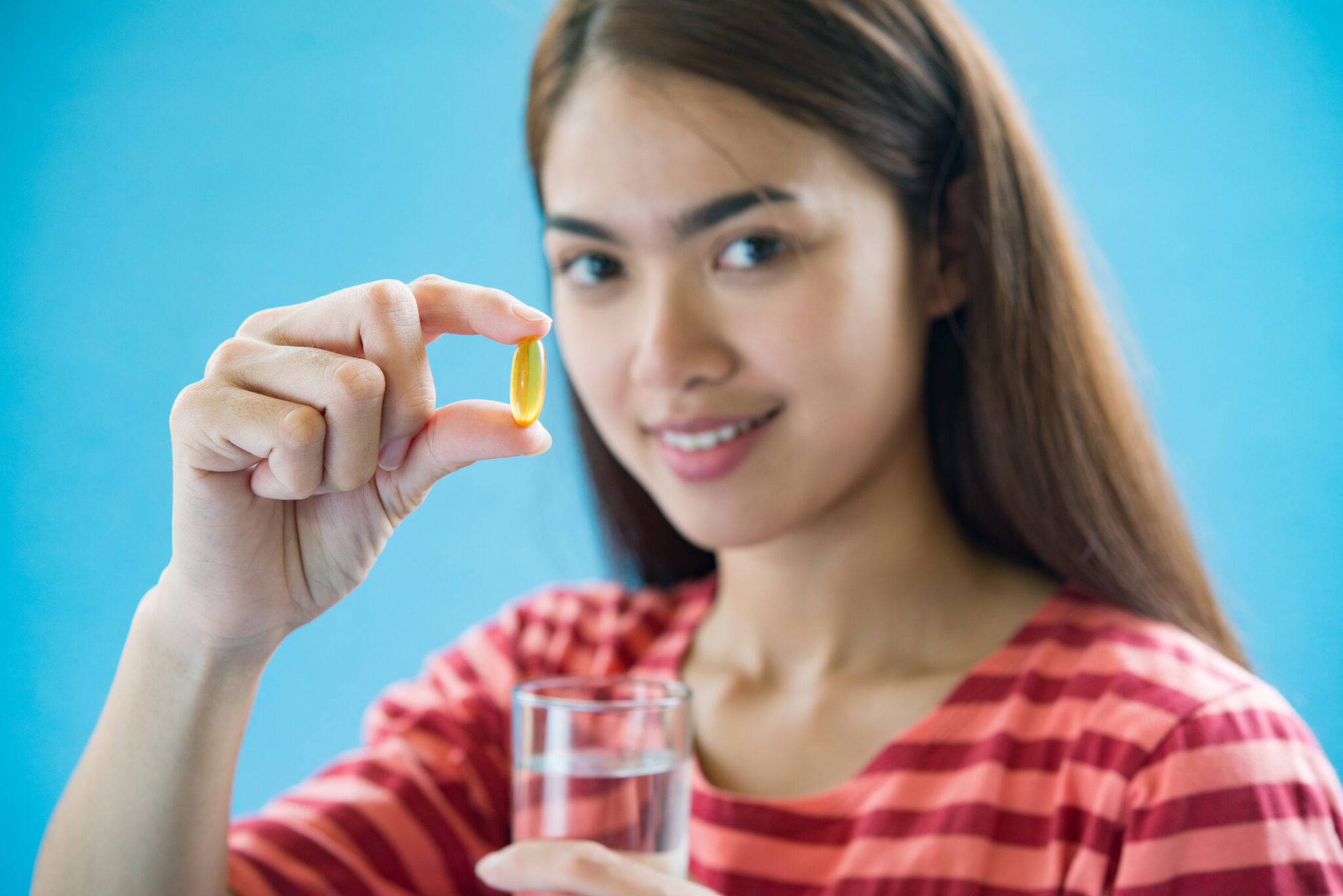 Young woman taking medicine pill after doctor order