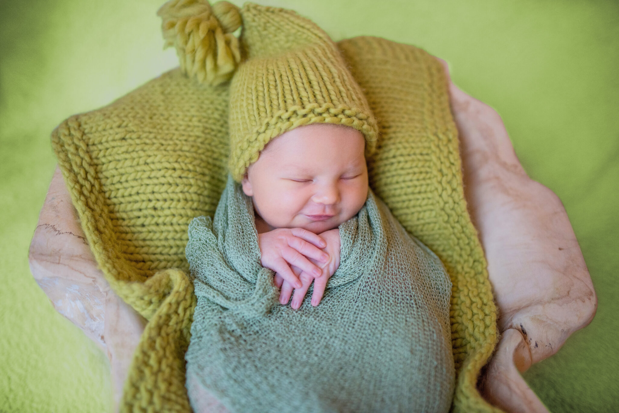 Little newborn baby in knitted clothes sleeps on the pillow